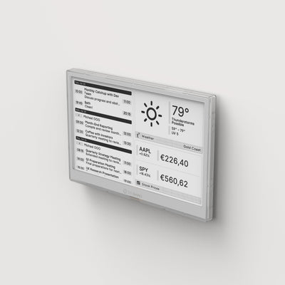 TRMNL display on a wall showing weather and stock information.