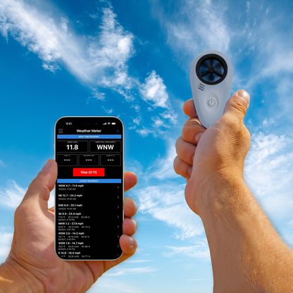 A hand holding the Tempest WINDmeter in the sky with another hand holding a smartphone with Tempest app
